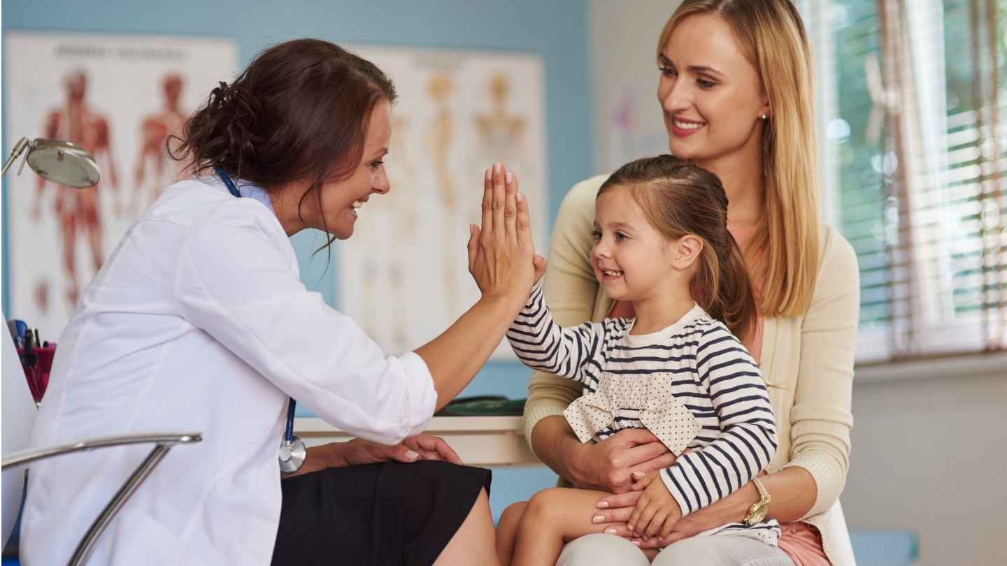 manchester-clinic-doctor-and-child Doctor speaking to a parent and child